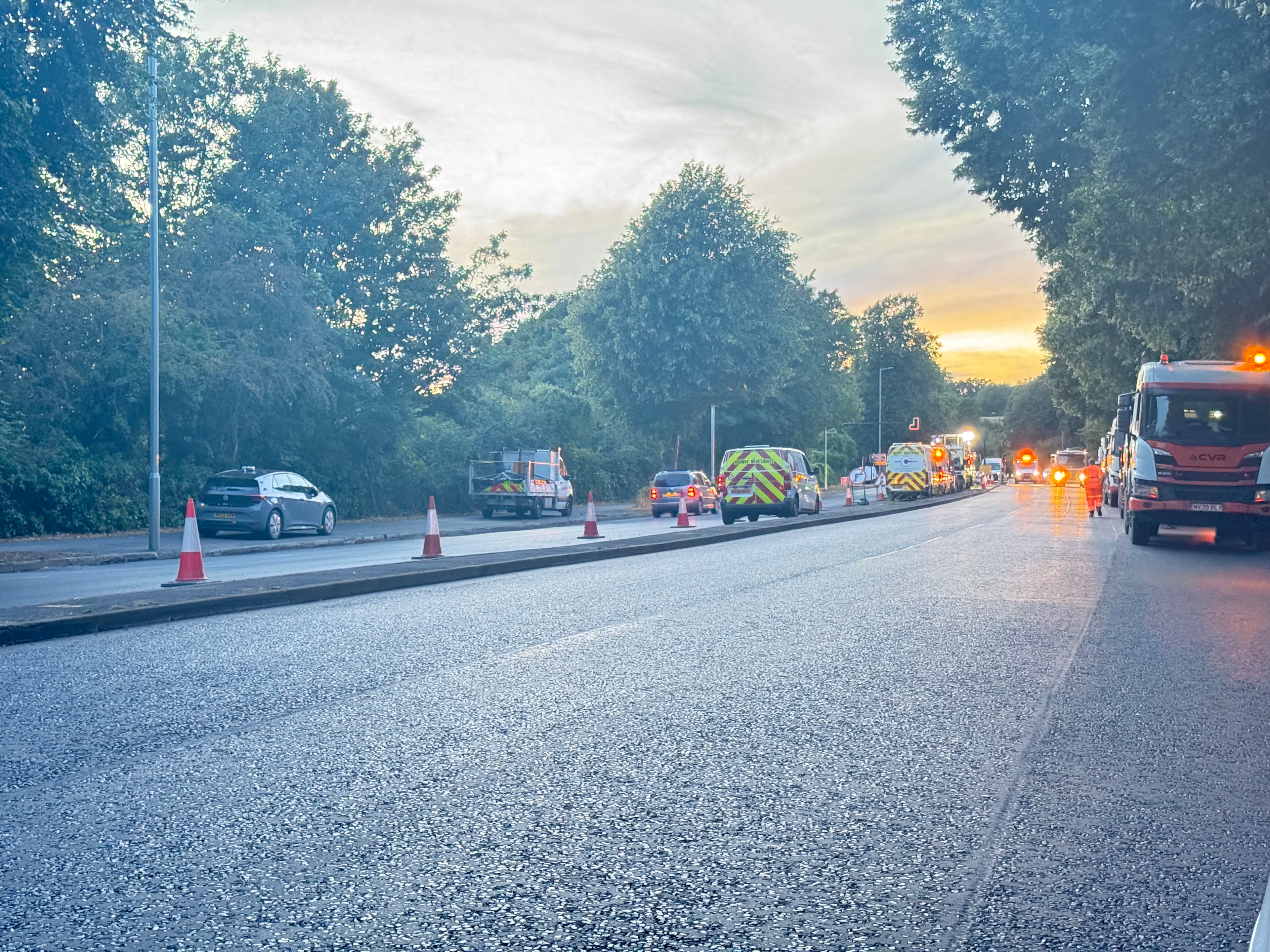 Road construction convoy at dusk — UK highway works